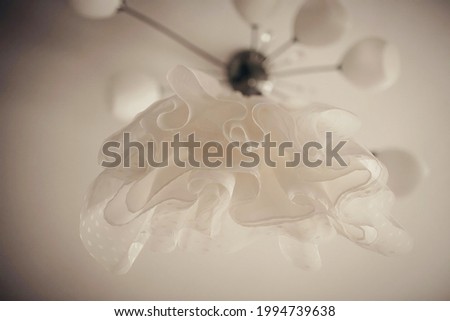 A white dress hangs on a chandelier