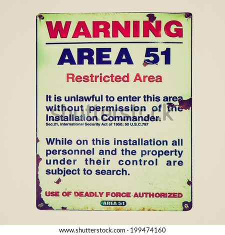 Vintage retro looking Vintage Area 51 warning sign isolated over white