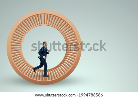 A man in a suit runs in a hamster wheel. The concept of liberation from slavery, life, business, manipulation, control