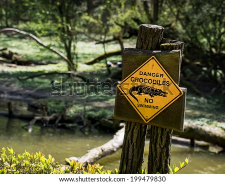 Danger crocodiles, no swimming - warning sign.