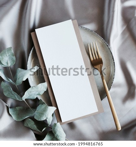 Menu card mockup on empty modern minimal table place setting neutral beige color.  Space for text. Scandinavian style.