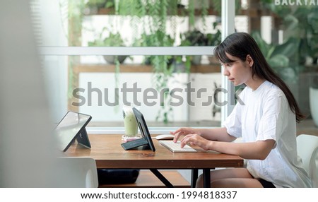 Young beautiful asian woman using computer work from home, Young female student using tablet computer for online learning while stay at home.