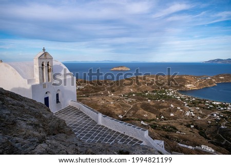 Greece Cyclades. Serifos island, Livadi cityscape and port aerial drone view from Chora town. Rocky landscape, white small houses, calm Aegean Sea, blue sky background. Summer holidays destination