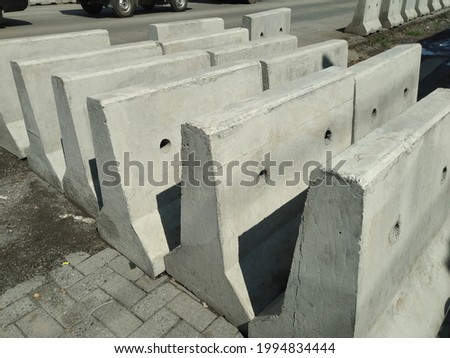 New gray movable barriers concrete by the roadside Royalty-Free Stock Photo #1994834444