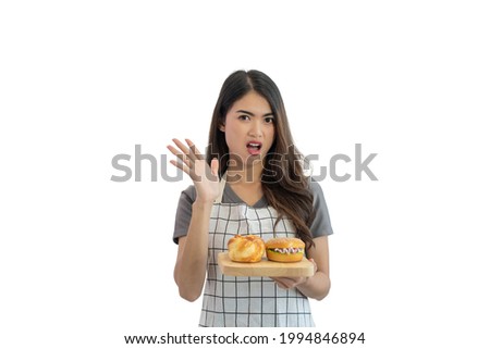 Unhappy young Asian woman looking at a burger and thinking refuses to eat junk food isolated on white background, Unhealthy eating concept
