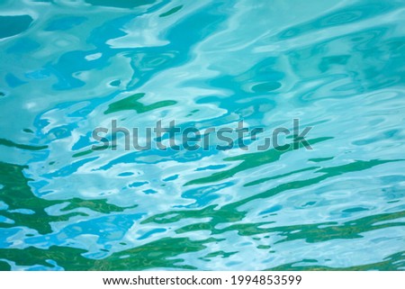 Blurred background with water reflections in turquoise shades