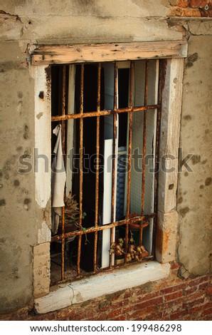 old window with rusty lattice in Venice