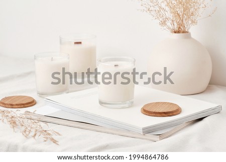 Handmade scented candles in a glass with a wooden lid. Soy wax candles with a wooden wick. Royalty-Free Stock Photo #1994864786