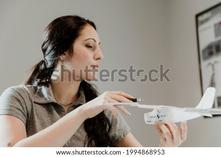Airwoman studying the aerodynamics of a plane
