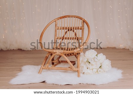 A vintage chair for a toddler to sit during a photo session in a photo studio