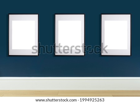 Mock up poster frame in interior wall. White frame for poster or photo image on blue wall in home room or office interior