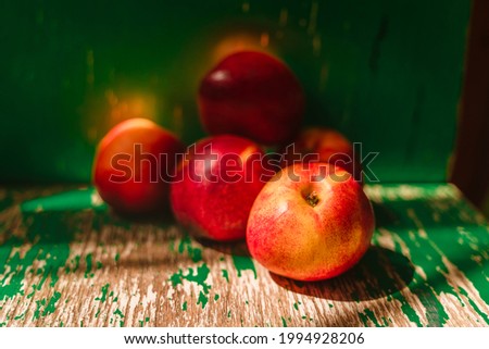 Still life with nectarines on a wooden green board
