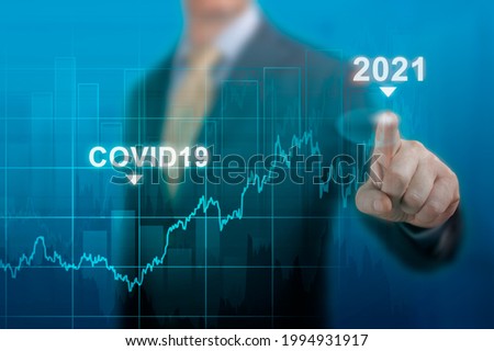 global economy concept of economic recovery after the fall due to the covid 19 coronavirus pandemic. Businessman pointing graph corporate future growth plan on dark blue. restart economy after crisis