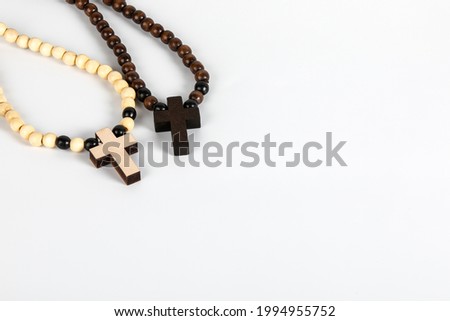 Two wooden crosses on a white background. Copy space.