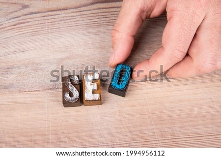 SEO. Search Engine Optimization concept. Colored letters of the alphabet on a wooden surface.