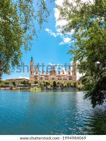 Picture of "Nuestra señora del Pilar" basilica in front of Ebro river captured during a sunny day. Zaragoza, Aragón, Spain.