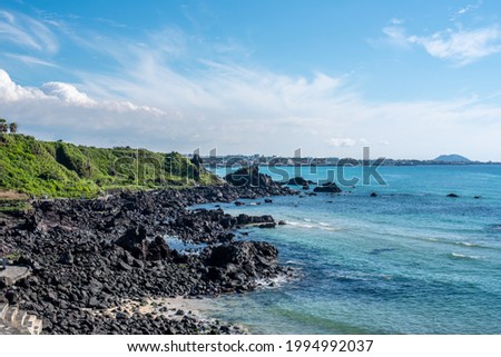 The beautiful emerald-colored sea of ​​Jeju Island is a popular tourist destination for Koreans. Royalty-Free Stock Photo #1994992037