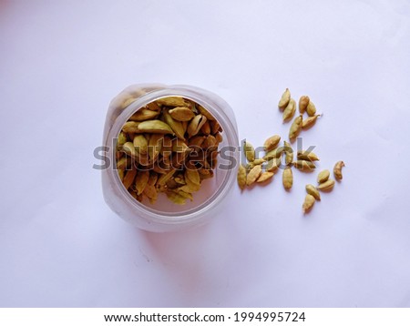 Group or collection of Cardamom, A partially dried fruit. Cardamom grains on isolated white background. Cardamom scattered on white background. Close-up picture. Top view