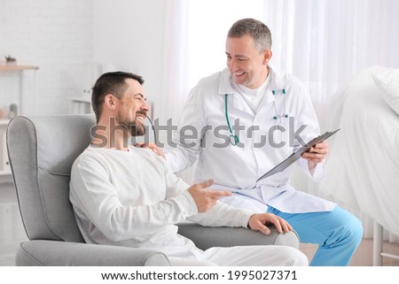 Doctor and man undergoing course of chemotherapy in clinic. Prostate cancer awareness concept Royalty-Free Stock Photo #1995027371