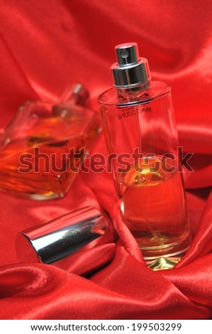 Perfume bottle on black silk background