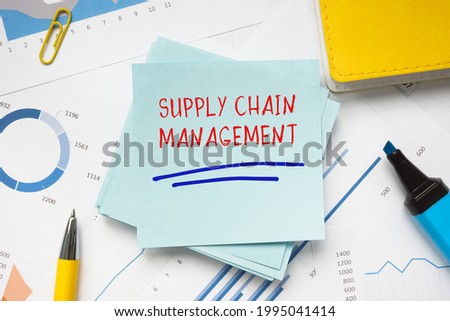 Financial concept meaning SUPPLY CHAIN MANAGEMENT with sign on the sheet. 
