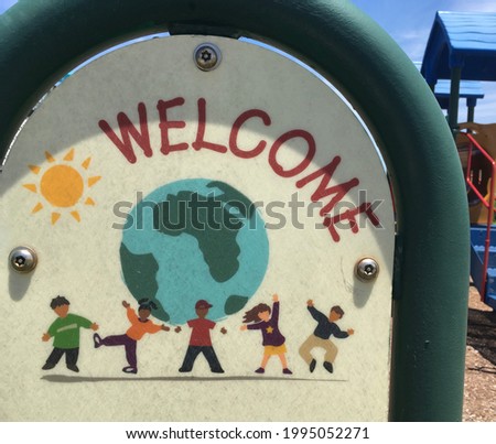Welcome sign from a children's playground featuring kids from around the world.