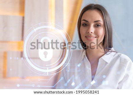 Portrait of attractive smiling businesswoman thinking how to protect clients confidential information and cyber security. IT hologram padlock icons over office background.