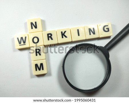 Selective focus.Toys letters with text NORM WORKING and magnifying glass on white background. Royalty-Free Stock Photo #1995060431