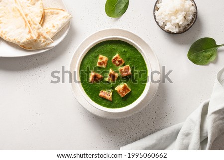 Indian vegetarian cuisine Palak Paneer of spinach and paneer cheese with chapati and basmati rice on white background. View from above. Royalty-Free Stock Photo #1995060662