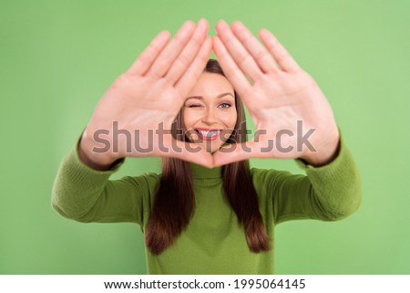Photo portrait happy woman showing border triangle with palms isolated pastel green color background Royalty-Free Stock Photo #1995064145