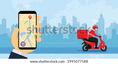 Hand holding smartphone with the man smile and riding a motorbike for delivery with happiness, for online shopping logistic and transportation concept, for delivery application with copy space