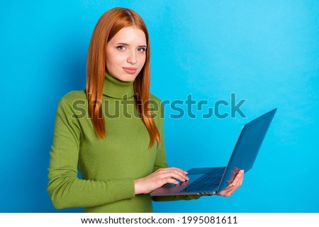 Photo of serious focused young woman hold hand laptop job work computer isolated on blue color background