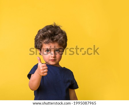 happy child and gestures concept. picture of smart boy showing thumbs up. Sign of like. Kindergarten or school student. Stylish pupil is ready to go to school.