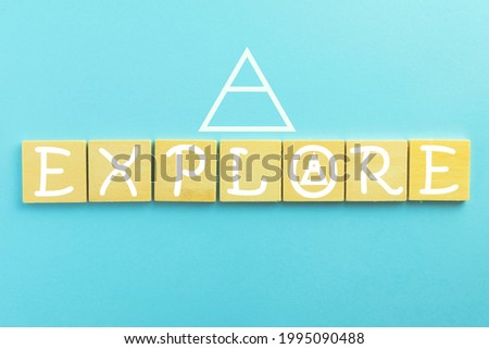 Explore word on wooden cube over blue sky pastel background with glyphs icon with copyspace use for hipster,glyphs concept. Royalty-Free Stock Photo #1995090488