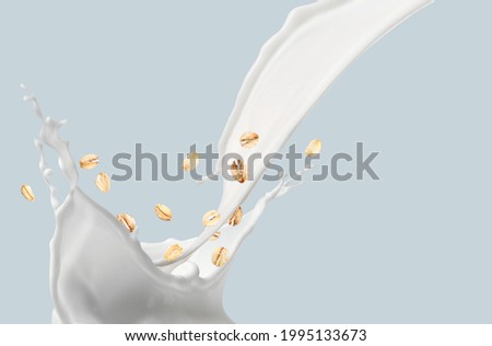 Splashes of oat milk on grey background Royalty-Free Stock Photo #1995133673