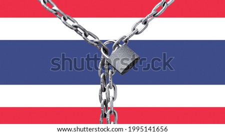 Metal chain and lock on Thailand flag. Concept of a ban on tourism due to the coronavirus pandemic, violation of the rights and freedoms of citizens
