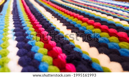 Colorful wave shaped carpet, including blue, lite blue, red, pink, white, green and yellow