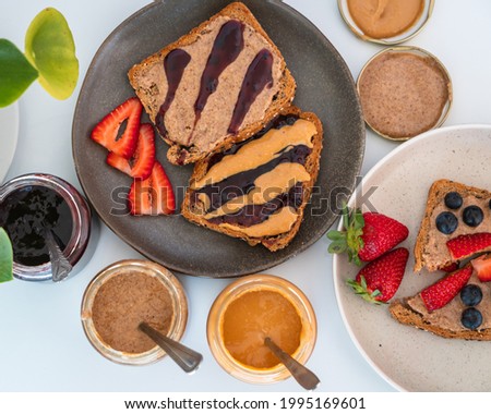 Top view of bread with peanut butter and almond bread with jelly