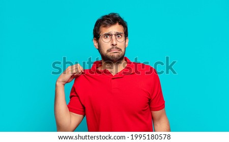 young handsome indian man doubting or uncertain expression
