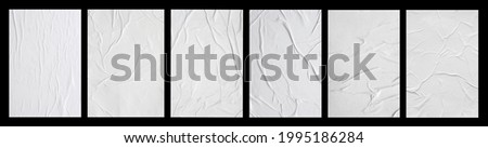 white crumpled and creased glued paper poster set isolated on black background Royalty-Free Stock Photo #1995186284