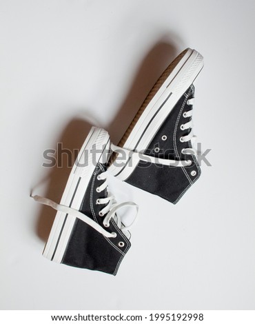 canvas shoes, casual shoes, black and white sneakers, on white background, with space for editing.