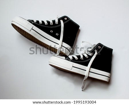 canvas shoes, casual shoes, black and white sneakers, on white background, with space for editing. Royalty-Free Stock Photo #1995193004