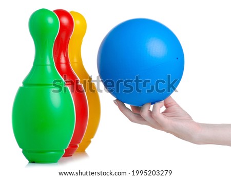 kids toy bowling skittles in hand on white background isolation