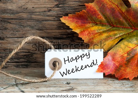 Happy Weekend written on a label with Autumnal Background Royalty-Free Stock Photo #199522289