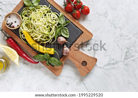 Raw vegetable spaghetti. Zucchini  pasta and fresh vegetables. Flat layot, copy space