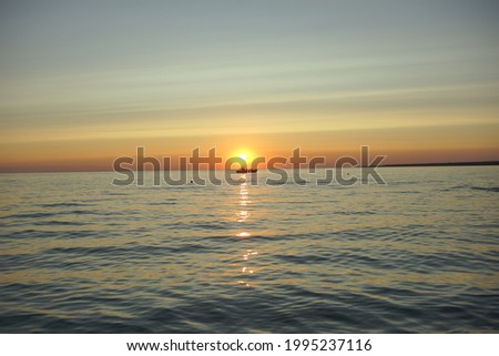 sunset and a boat on the horizont. beautiful landscape background. 