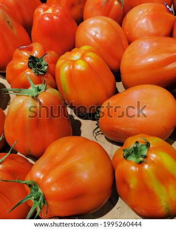 Group of red ripe tomatoes on the shop window, in the store