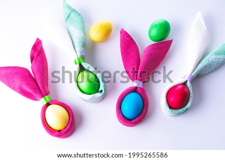 Easter eggs and the shape of rabbit ears, on a white background, selective focus, tinted image
