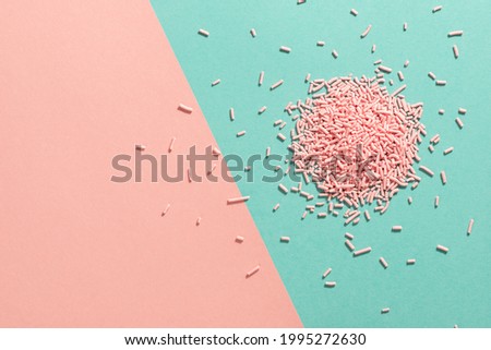 trendy pattern of colorful sprinkles for background of design banner, poster, flyer, card over pink and blue, minimal summer concept