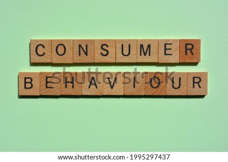Consumer Behaviour, words in wooden alphabet letters isolated on green background